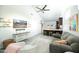 Open living room featuring vaulted ceiling, tile floors, modern fixtures and TV, flowing seamlessly into the kitchen area at 1321 E Brill St, Phoenix, AZ 85006