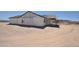 New construction shows exterior and covered patio with unfinished siding and framing, in a desert environment at 1664 N 431St Ave, Tonopah, AZ 85354