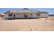 Unfinished siding of a new home build shows window placement, with construction framework visible, in a desert setting at 1664 N 431St Ave, Tonopah, AZ 85354