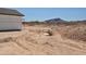A large hole in the ground of a construction site, with desert landscape and hills in background at 1664 N 431St Ave, Tonopah, AZ 85354