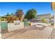 Back patio showcasing an outdoor kitchen with grill and a built-in fire pit, surrounded by lush landscaping at 21315 E Marsh Rd, Queen Creek, AZ 85142