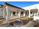 Extended back patio features an outdoor kitchen, fire pit, and ample space for dining and entertaining at 21315 E Marsh Rd, Queen Creek, AZ 85142