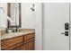 Bathroom featuring granite countertop, modern faucet, wood cabinets, and updated light fixture at 21315 E Marsh Rd, Queen Creek, AZ 85142