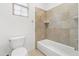 Bright bathroom with a tub and shower combination and a tiled accent wall at 21315 E Marsh Rd, Queen Creek, AZ 85142