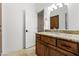 Bathroom featuring a granite countertop, wooden cabinets, a white door, and a towel at 21315 E Marsh Rd, Queen Creek, AZ 85142