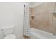 This bathroom features a tiled bathtub, toilet, and shower with a shower curtain at 21315 E Marsh Rd, Queen Creek, AZ 85142