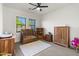 Comfortable bedroom with a ceiling fan, plush carpet and natural light at 21315 E Marsh Rd, Queen Creek, AZ 85142