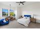Bedroom with many windows and a blue accent bean bag and comforter at 21315 E Marsh Rd, Queen Creek, AZ 85142