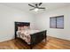 This bedroom has hardwood floors, a ceiling fan, and a dark wooden bed frame at 21315 E Marsh Rd, Queen Creek, AZ 85142