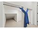 Walk in closet space with blue curtain covering rods at 21315 E Marsh Rd, Queen Creek, AZ 85142