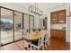 Dining area with wood floors and cabinet space that is adjacent to sliding glass door to the patio at 21315 E Marsh Rd, Queen Creek, AZ 85142