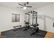 Gym area with weights and a rack system and windows for plenty of light at 21315 E Marsh Rd, Queen Creek, AZ 85142