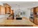 Spacious kitchen with granite countertops, dark cabinetry, stainless steel appliances, and an island at 21315 E Marsh Rd, Queen Creek, AZ 85142