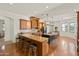 Bright, open kitchen with granite countertops, dark cabinets, stainless steel appliances, and an island at 21315 E Marsh Rd, Queen Creek, AZ 85142