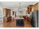 Well-appointed kitchen featuring granite countertops, dark cabinetry, stainless steel appliances, and hardwood floors at 21315 E Marsh Rd, Queen Creek, AZ 85142
