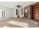 Cozy living room with stone fireplace, built-in bookshelves, and a large window for natural light at 21315 E Marsh Rd, Queen Creek, AZ 85142