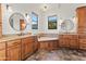 Main bathroom with dual sinks, granite countertops, vanity, and a soaking tub for relaxation at 21315 E Marsh Rd, Queen Creek, AZ 85142