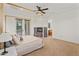 Spacious main bedroom suite with a stone fireplace, ceiling fan, and access to a private outdoor space at 21315 E Marsh Rd, Queen Creek, AZ 85142