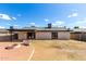 Large backyard featuring a covered patio, three fire pits, and lush landscaping is ideal for outdoor living at 3008 W Michigan Ave, Phoenix, AZ 85053