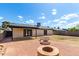 Backyard with brick patio, three fire pits, and covered patio is perfect for relaxing and entertaining outdoors at 3008 W Michigan Ave, Phoenix, AZ 85053