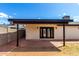 Backyard with a covered patio and brick accents is ideal for outdoor dining and entertaining with stylish design at 3008 W Michigan Ave, Phoenix, AZ 85053