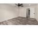 Bedroom featuring luxury vinyl plank flooring, ceiling fan and white trim at 3008 W Michigan Ave, Phoenix, AZ 85053