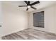 Clean bedroom features luxury vinyl plank flooring, modern window shade, and ceiling fan at 3008 W Michigan Ave, Phoenix, AZ 85053