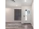 Bright entryway features modern horizontal shades, clean white walls and wood-look floors at 3008 W Michigan Ave, Phoenix, AZ 85053