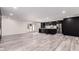 Open concept living area featuring kitchen with dark cabinetry, quartz countertops, and stainless appliances at 3008 W Michigan Ave, Phoenix, AZ 85053