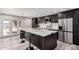Stylish kitchen features waterfall island, stainless appliances, and sleek black cabinetry at 3008 W Michigan Ave, Phoenix, AZ 85053
