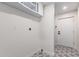 The laundry room has patterned floor and white cabinets for storage at 3008 W Michigan Ave, Phoenix, AZ 85053