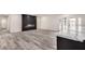 Bright living space with luxury vinyl plank flooring, fireplace accent wall and sliding glass doors to backyard at 3008 W Michigan Ave, Phoenix, AZ 85053