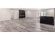 Spacious open-concept living room showcasing modern fireplace, wood-look floors and neutral paint at 3008 W Michigan Ave, Phoenix, AZ 85053