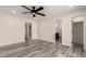 Spacious main bedroom featuring wood-look floors, ceiling fan, and multiple entryways at 3008 W Michigan Ave, Phoenix, AZ 85053