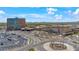 Aerial view of Casino, parking, and surrounding community, making it a great place to live at 45144 W Desert Garden Rd, Maricopa, AZ 85139
