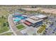 Community center with a pool, ample parking, and surrounding green space, aerial view at 45144 W Desert Garden Rd, Maricopa, AZ 85139