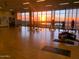 Bright exercise room with sunset views featuring state of the art exercise equipment at 45144 W Desert Garden Rd, Maricopa, AZ 85139