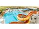 Large pool with slide, featuring lots of people and plenty of room for everyone at 45144 W Desert Garden Rd, Maricopa, AZ 85139