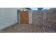 Side yard featuring a wooden fence with rocks on the ground and a cinder block wall at 5421 W Villa Rita Dr, Glendale, AZ 85308