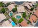 An aerial view of a single-Gathering home and neighborhood featuring green spaces and community pools at 870 N Criss St, Chandler, AZ 85226