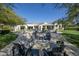 Stunning backyard features a modern fire pit and inviting lounge area with comfortable seating at 10160 E Whispering Wind Dr, Scottsdale, AZ 85255