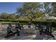 Charming backyard with a stone fire pit, surrounded by comfortable seating and lush greenery at 10160 E Whispering Wind Dr, Scottsdale, AZ 85255