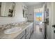 Bright bathroom with double sinks, framed mirrors, and access to the shower room offers space and functionality at 10160 E Whispering Wind Dr, Scottsdale, AZ 85255