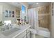 Bathroom featuring a white vanity with a white countertop, shower-tub combination, neutral accents, and natural lighting at 10160 E Whispering Wind Dr, Scottsdale, AZ 85255