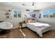 Bright bedroom features a comfortable bed, bright windows, and hardwood floors creates a peaceful retreat at 10160 E Whispering Wind Dr, Scottsdale, AZ 85255