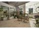 Serene courtyard with stone accents, potted plants, and comfortable seating under ambient string lights at 10160 E Whispering Wind Dr, Scottsdale, AZ 85255