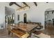 Stylish dining room with designer lighting, rustic table, and elegant decor at 10160 E Whispering Wind Dr, Scottsdale, AZ 85255