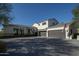Stunning home featuring a multi-car garage, neutral color palette, and manicured landscaping, offering timeless curb appeal at 10160 E Whispering Wind Dr, Scottsdale, AZ 85255