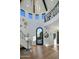 Grand foyer features soaring ceilings, a statement wrought iron staircase, and an ornate front door at 10160 E Whispering Wind Dr, Scottsdale, AZ 85255