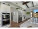Elegant kitchen with stainless steel appliances, white cabinetry, and granite countertops at 10160 E Whispering Wind Dr, Scottsdale, AZ 85255